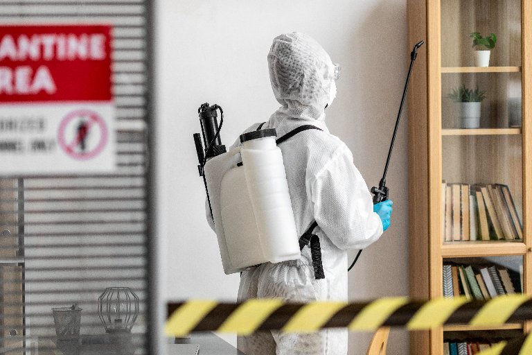 Mold remediation technician performing containment and treatment inside a Denver residential property
